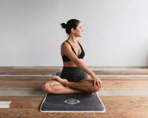 woman doing yoga after coolsculpting treatment